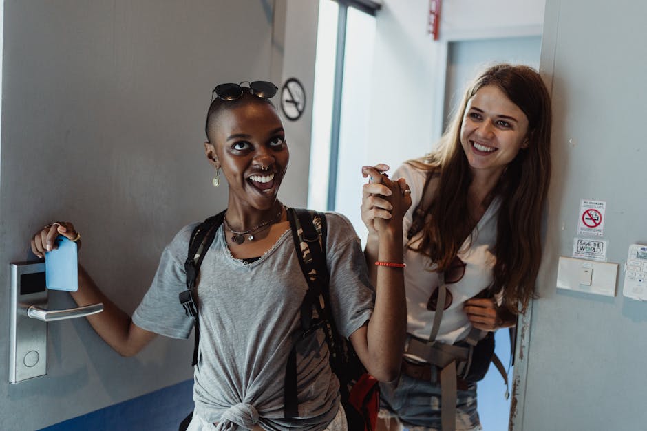 Two cheerful women entering a modern room, capturing moments of fun and friendship.