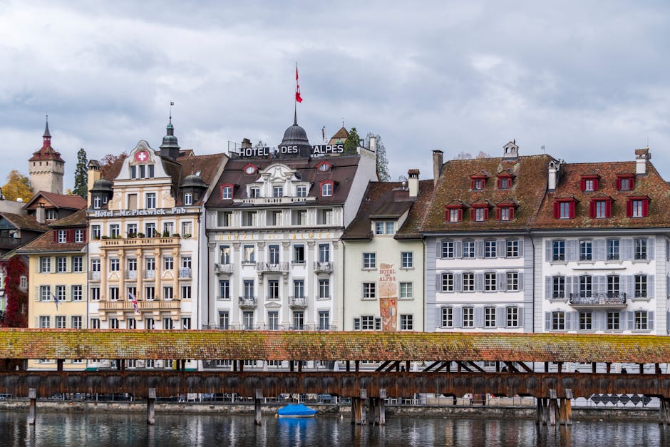 Scenic view of historic buildings and Chapel Bridge in Lucerne, embracing Swiss architectural charm.