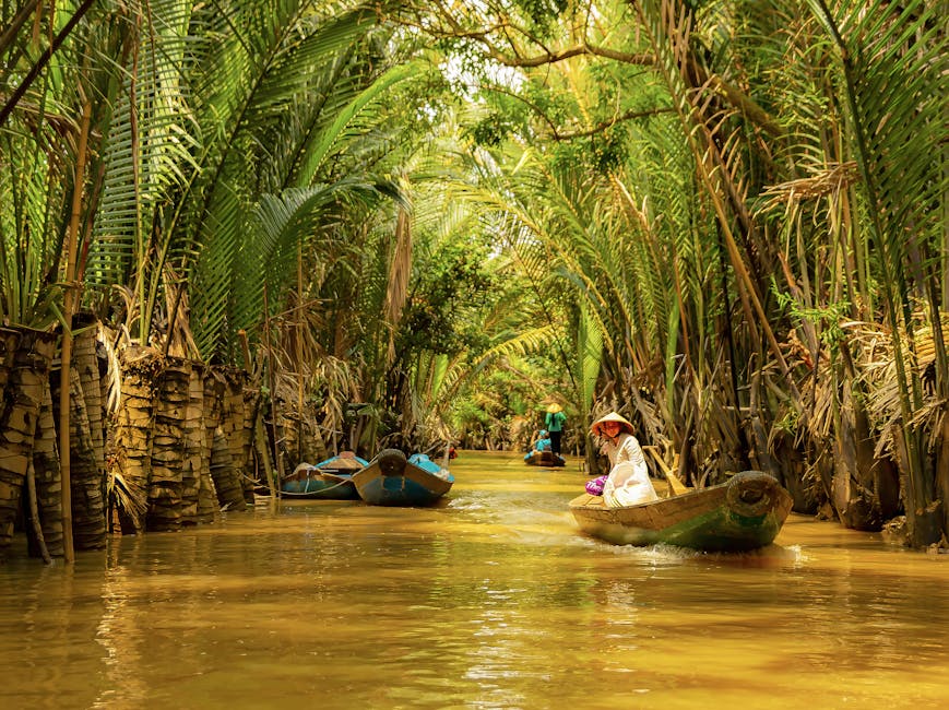 A peaceful journey down a tropical canal with boats and lush greenery.