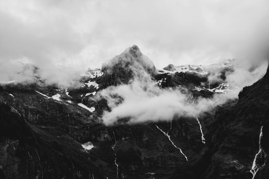 Black and white landscape of Sixt-Fer-à-Cheval mountains shrouded in cloud.