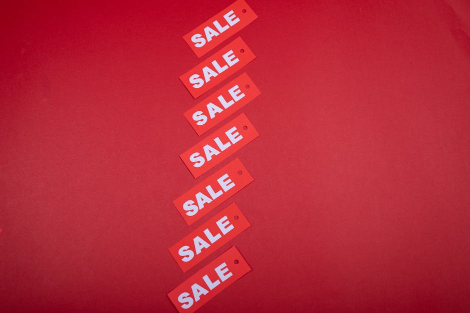 Diagonal row of red sale tags on a red background. Ideal for advertising promotions.