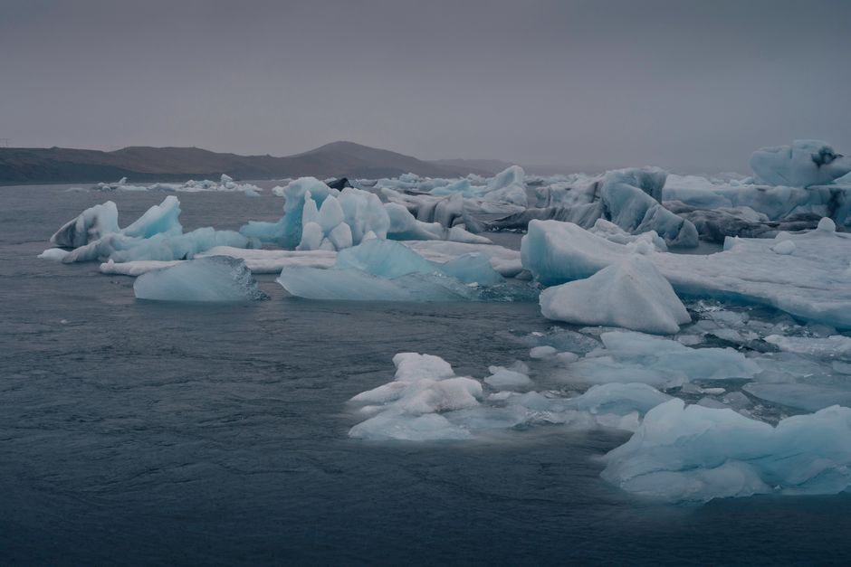 Stunning view of icebergs drifting in the serene waters of Iceland's coast.