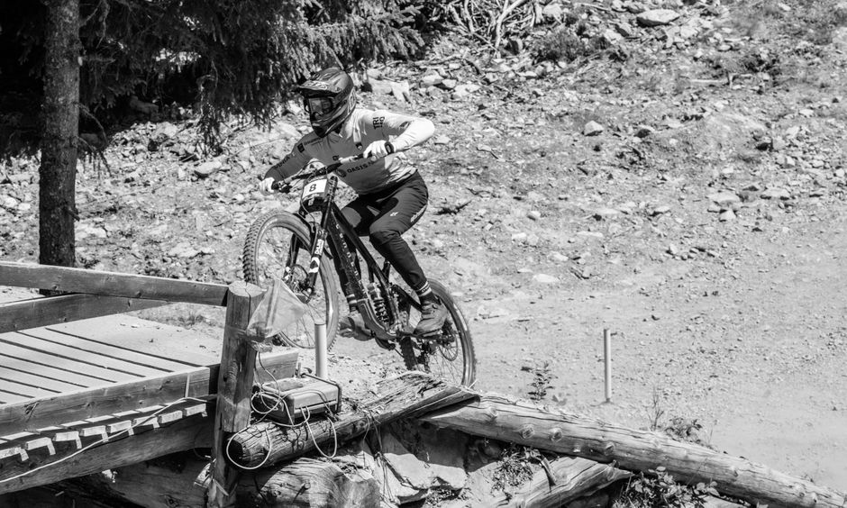 Mountain biker descending a rocky trail in Switzerland