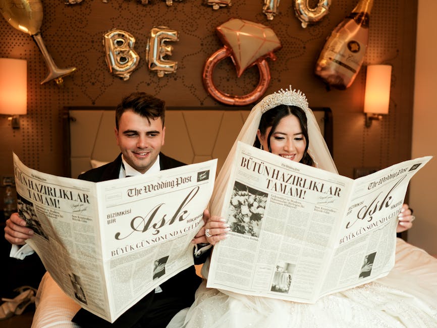 Elegant wedding couple reading newspapers with festive balloons in the background.