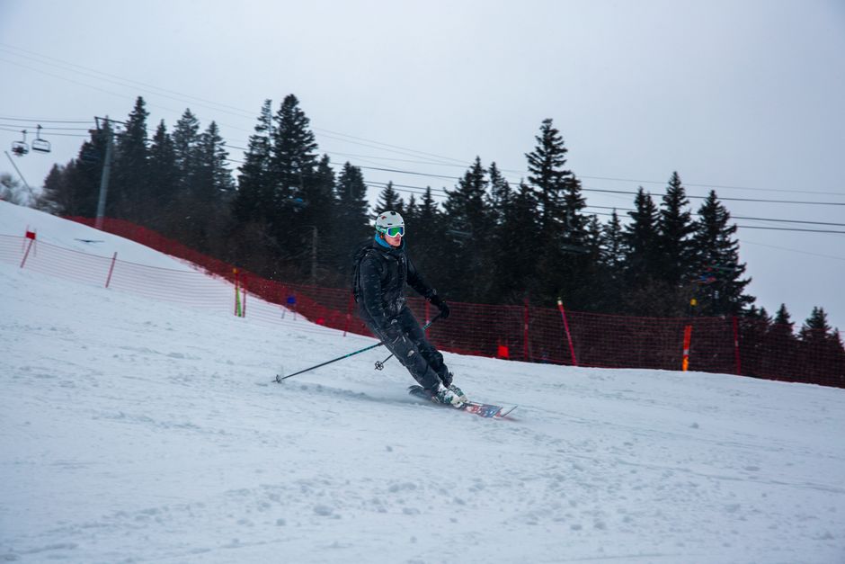 Exciting skiing scene in Les Contamines-Montjoie with a skier on a snowy slope.